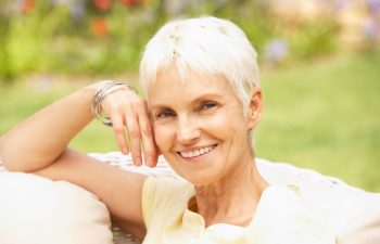 An older woman with bright white, healthy teeth, smiling