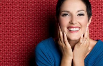 A smiling woman with bright, white, healthy looking teeth