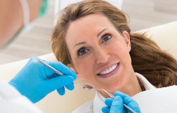 smiling female patient of the dentist
