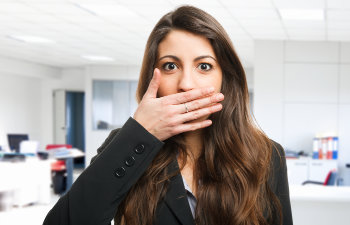 woman covers her mouth because she has bad breath